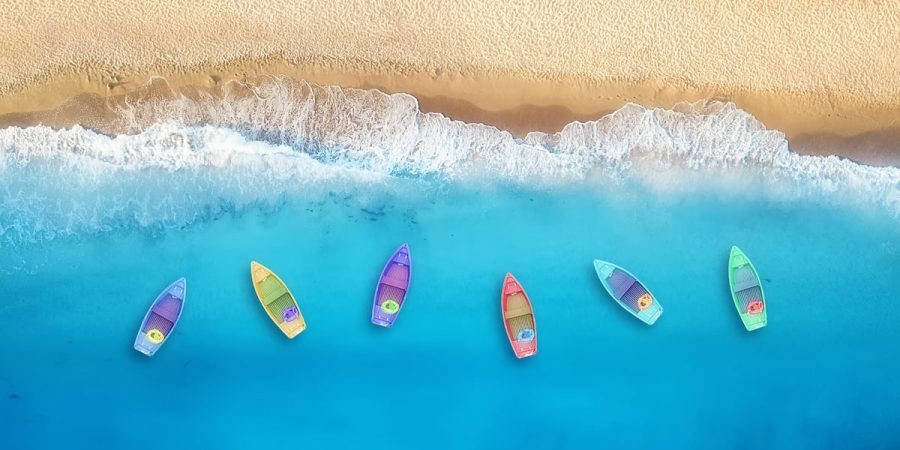 Boats from air. Aerial view on sea in Turkey. Summer seascape with clear water and sandy beach in sunny day. Top view of boats from drone. Summer seascape from air. Travel - image